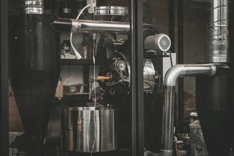 Commercial coffee-roasting equipment with steel ducting and a cooling vessel