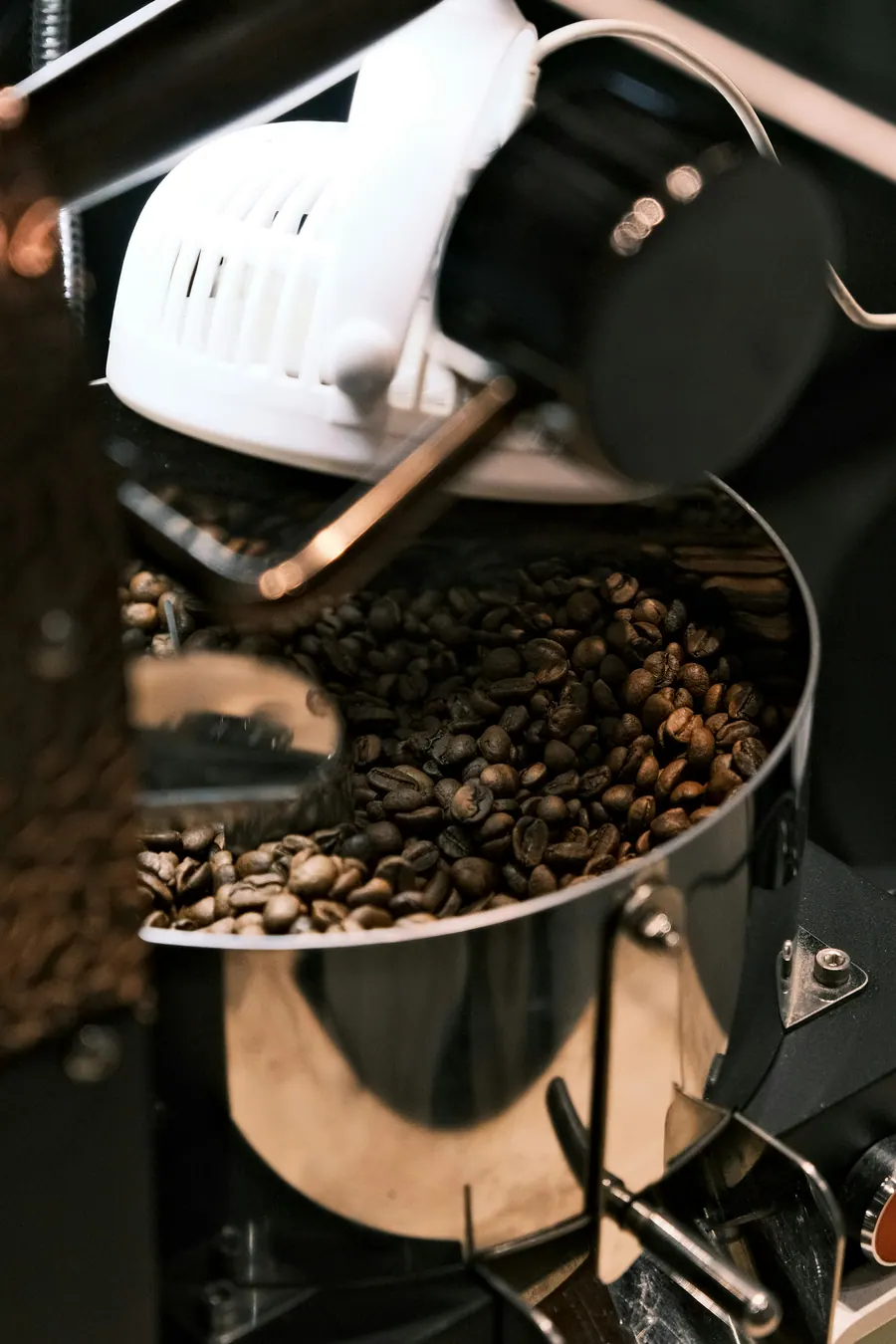 Roasted coffee beans circulating in the cooling tray of a coffee roaster